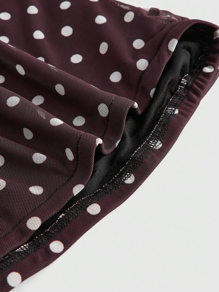 Women's black polka dot strapless tube top made of ruched mesh fabric featuring an asymmetrical hem and matching scarf.