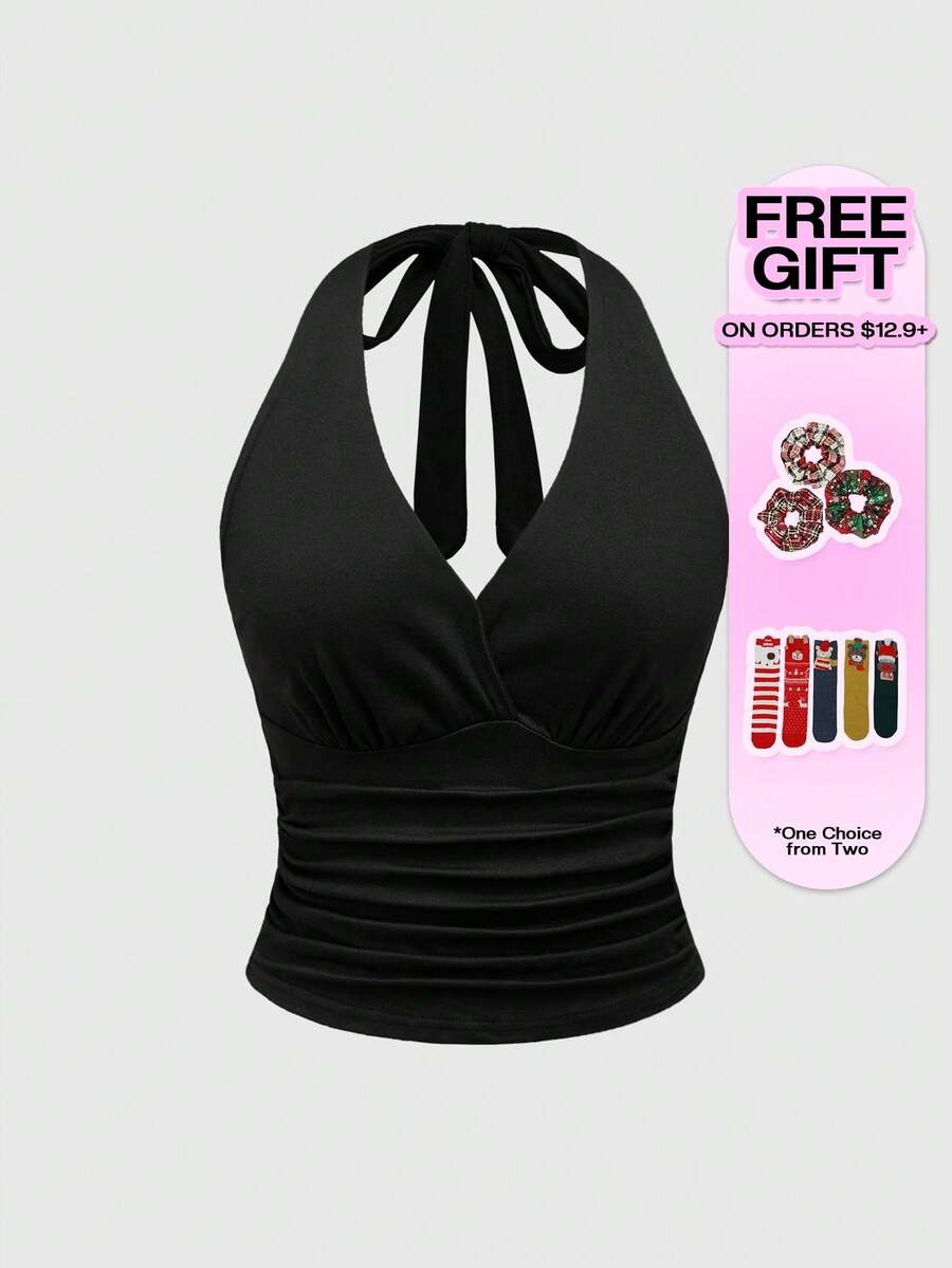 Women's halter crop tank top featuring a backless silhouette and ruched detailing in a slim fit design.