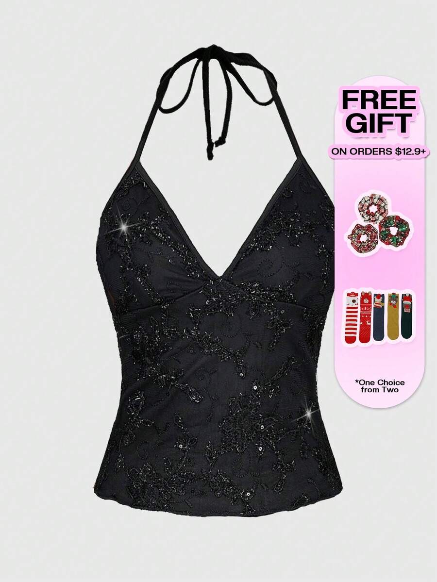 Women's black mesh sequin halter top featuring a backless design, knot details, and lace fabric.
