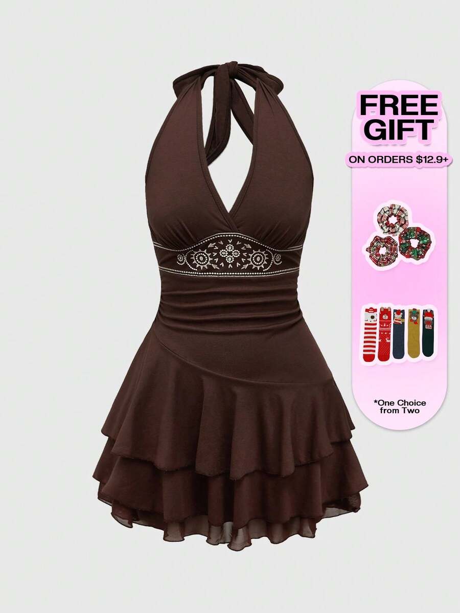 Women's sun totem embroidered sleeveless layered mini dress featuring a halter neck, backless tie back design, and slim fit high-waist A-line silhouette.