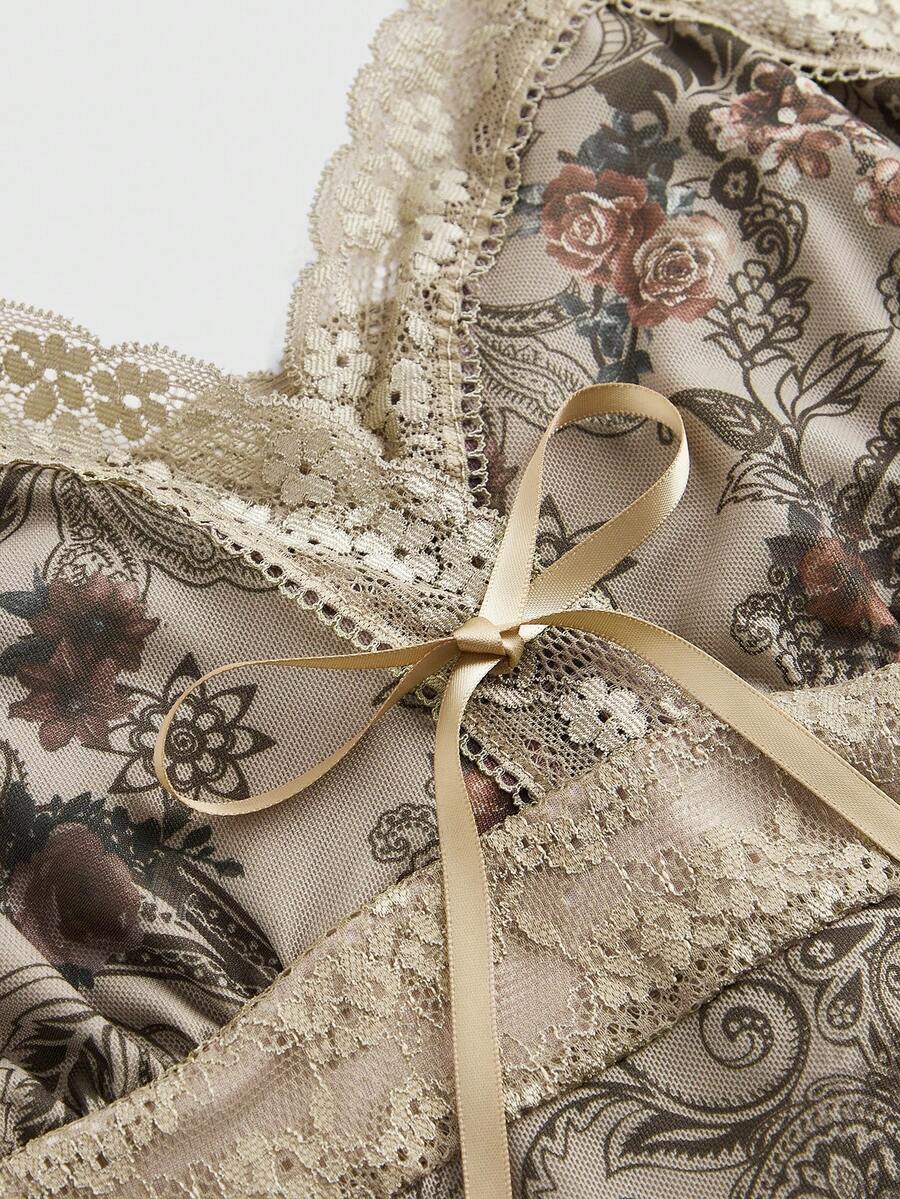 A women's sleeveless crop camisole featuring a vintage paisley print design with delicate lace trim along the neckline and thin spaghetti straps.