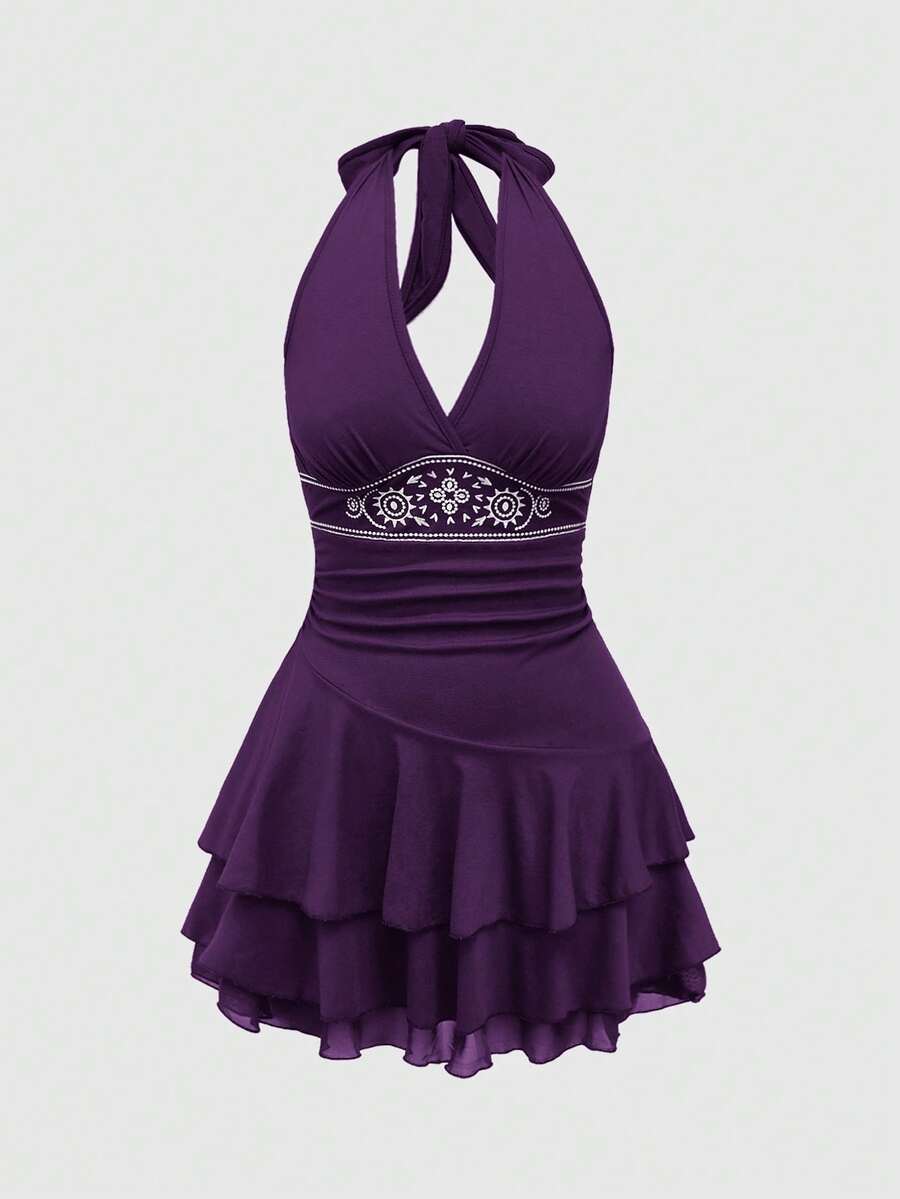 Women's sun totem embroidered sleeveless layered mini dress featuring a halter neck, backless tie back design, and slim fit high-waist A-line silhouette.