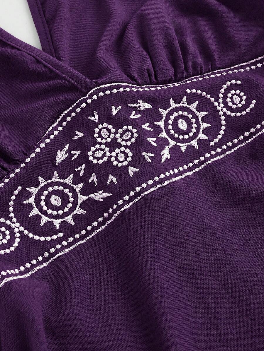 Women's sun totem embroidered sleeveless layered mini dress featuring a halter neck, backless tie back design, and slim fit high-waist A-line silhouette.