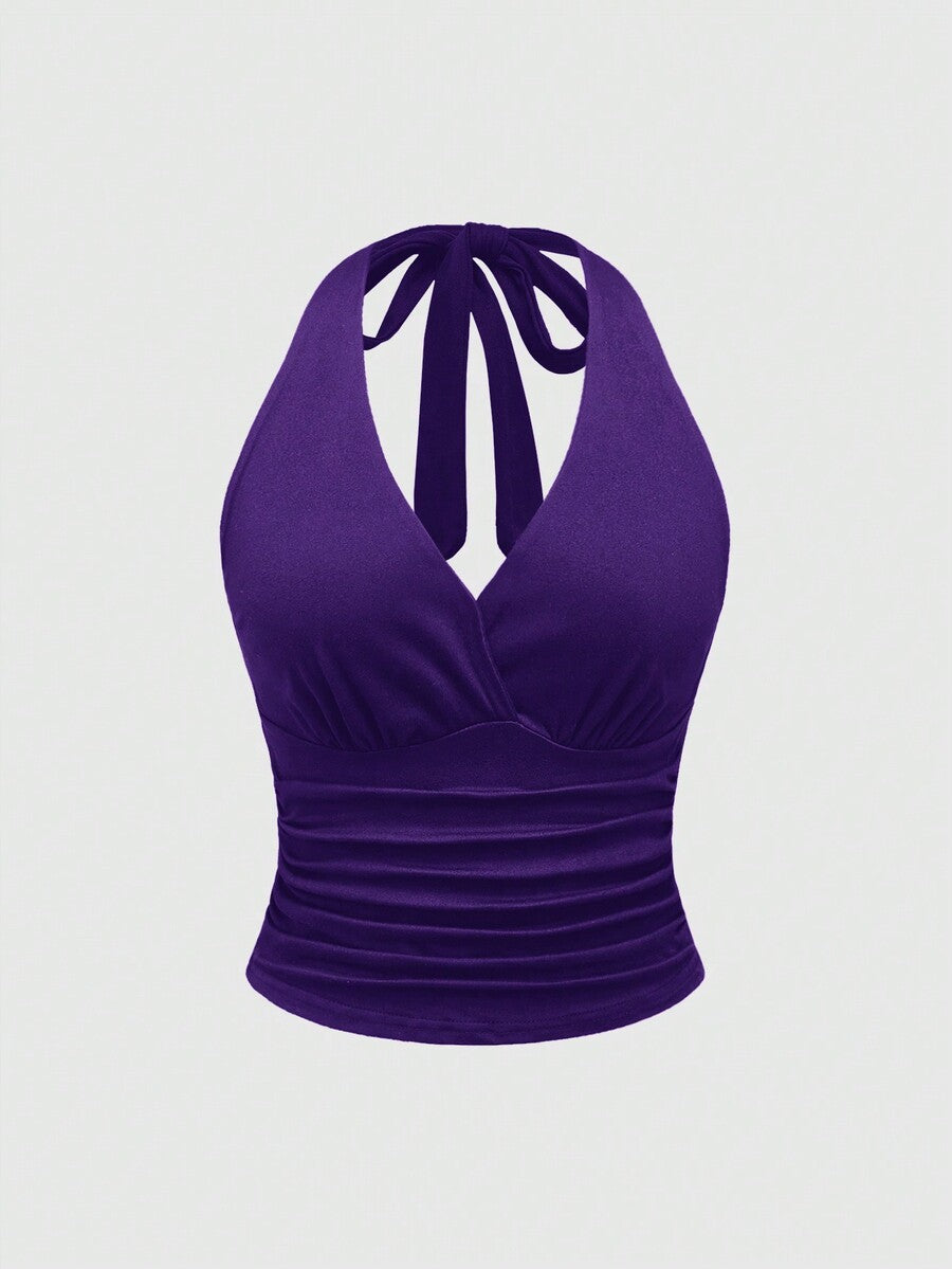 Women's halter crop tank top featuring a backless silhouette and ruched detailing in a slim fit design.
