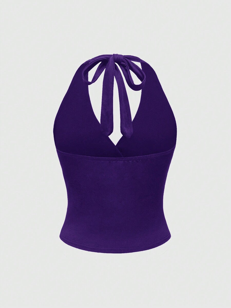 Women's halter crop tank top featuring a backless silhouette and ruched detailing in a slim fit design.