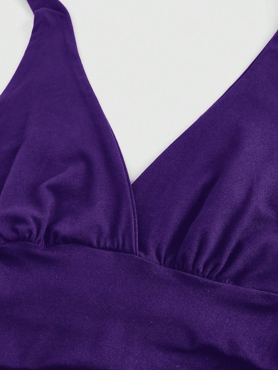 Women's halter crop tank top featuring a backless silhouette and ruched detailing in a slim fit design.