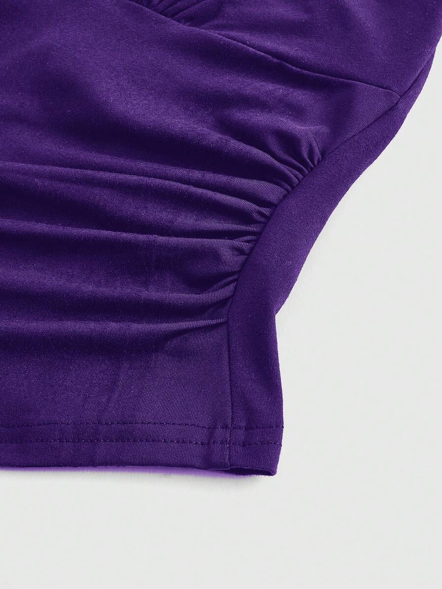 Women's halter crop tank top featuring a backless silhouette and ruched detailing in a slim fit design.