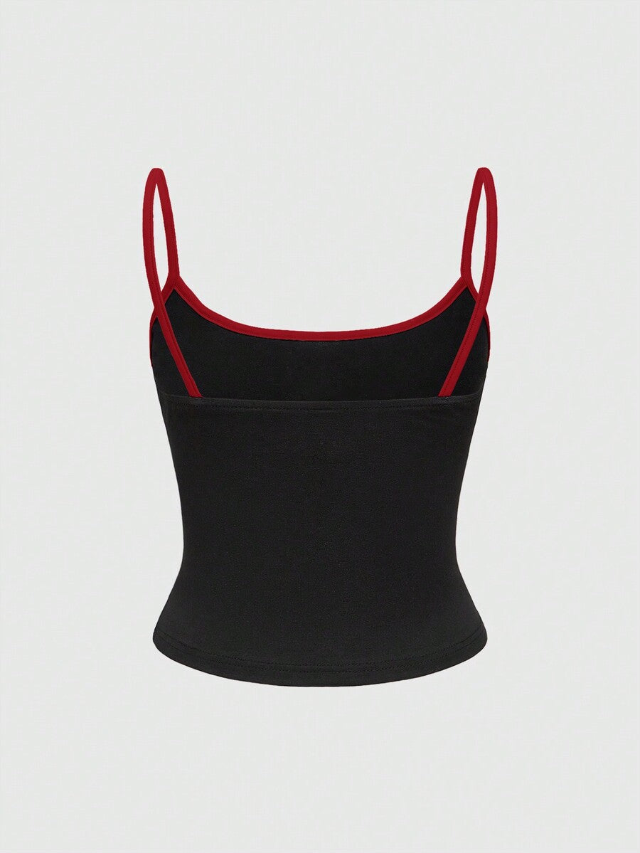 Black ribbed cropped cami top featuring a white bat graphic print on the front with spaghetti straps and contrast binding trim.