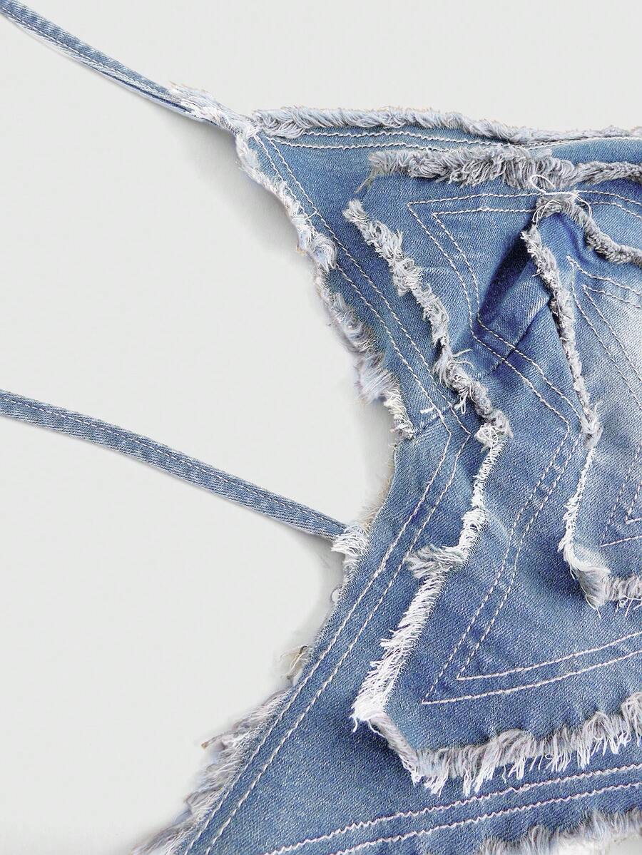 Blue denim halter tank top for women featuring distressed star patch detail, asymmetrical crop hem, and backless tie-back design.