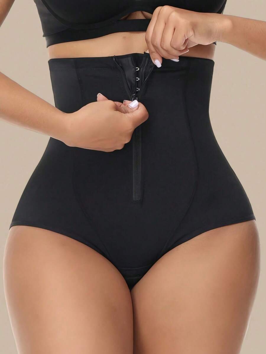 Women's black super high waist shaping pants with zipper closure, strong tummy control, and butt lifting feature.