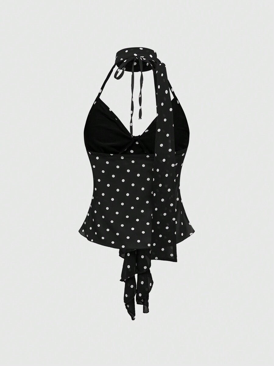 Black halter crop top featuring an asymmetrical ruffle hem and backless design for women.