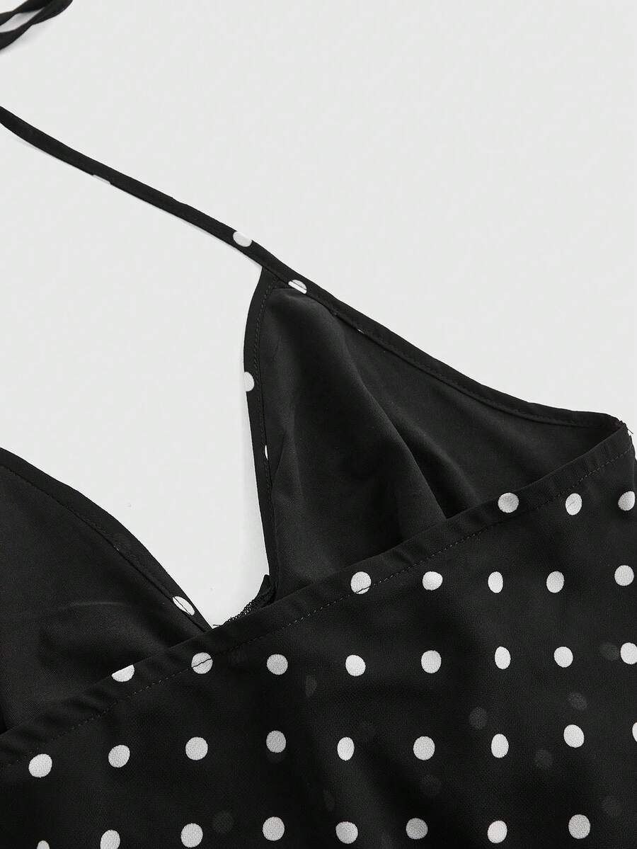 Black halter crop top featuring an asymmetrical ruffle hem and backless design for women.