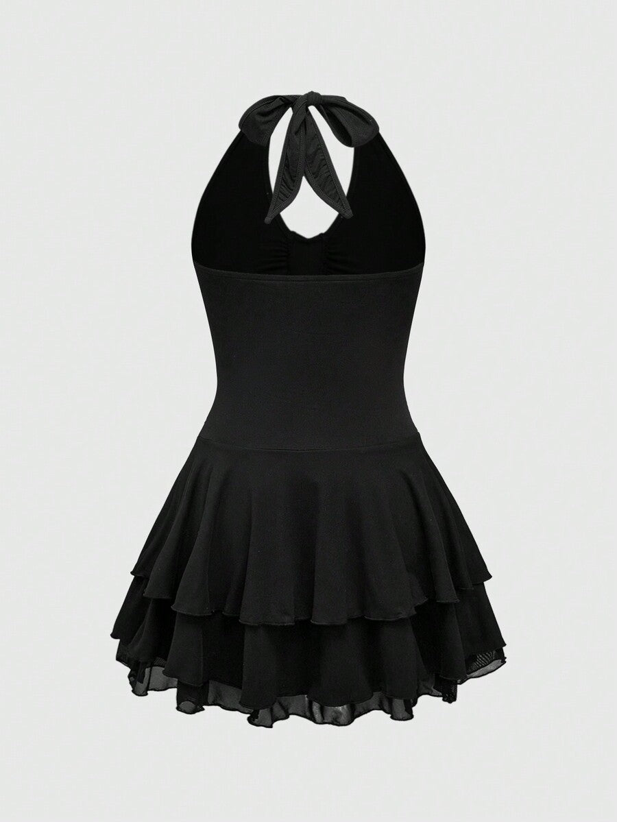 Front view of women's black sleeveless halter mini dress featuring a backless slim fit silhouette and tiered ruffle hem.