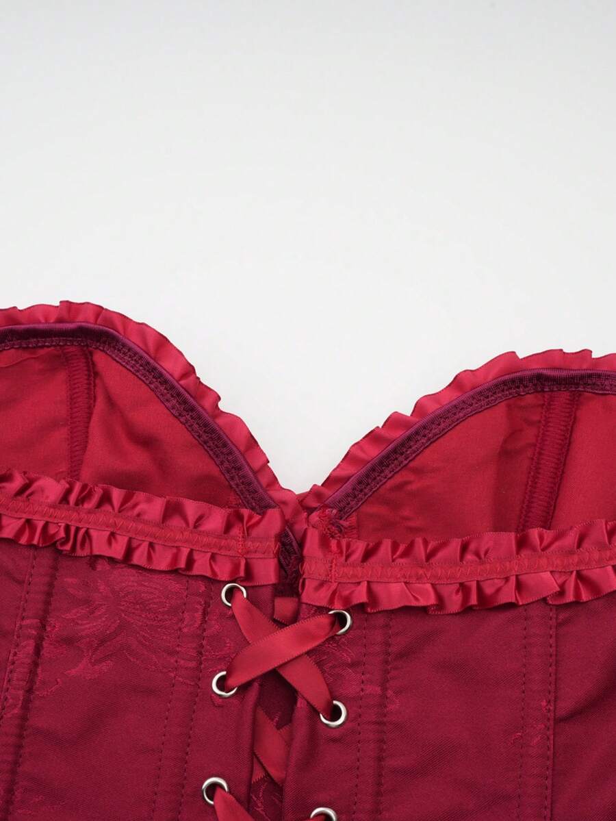 Women’s strapless corset bustier top with front button detail, lace-up back, frill accents, slim fit, and asymmetrical hem.