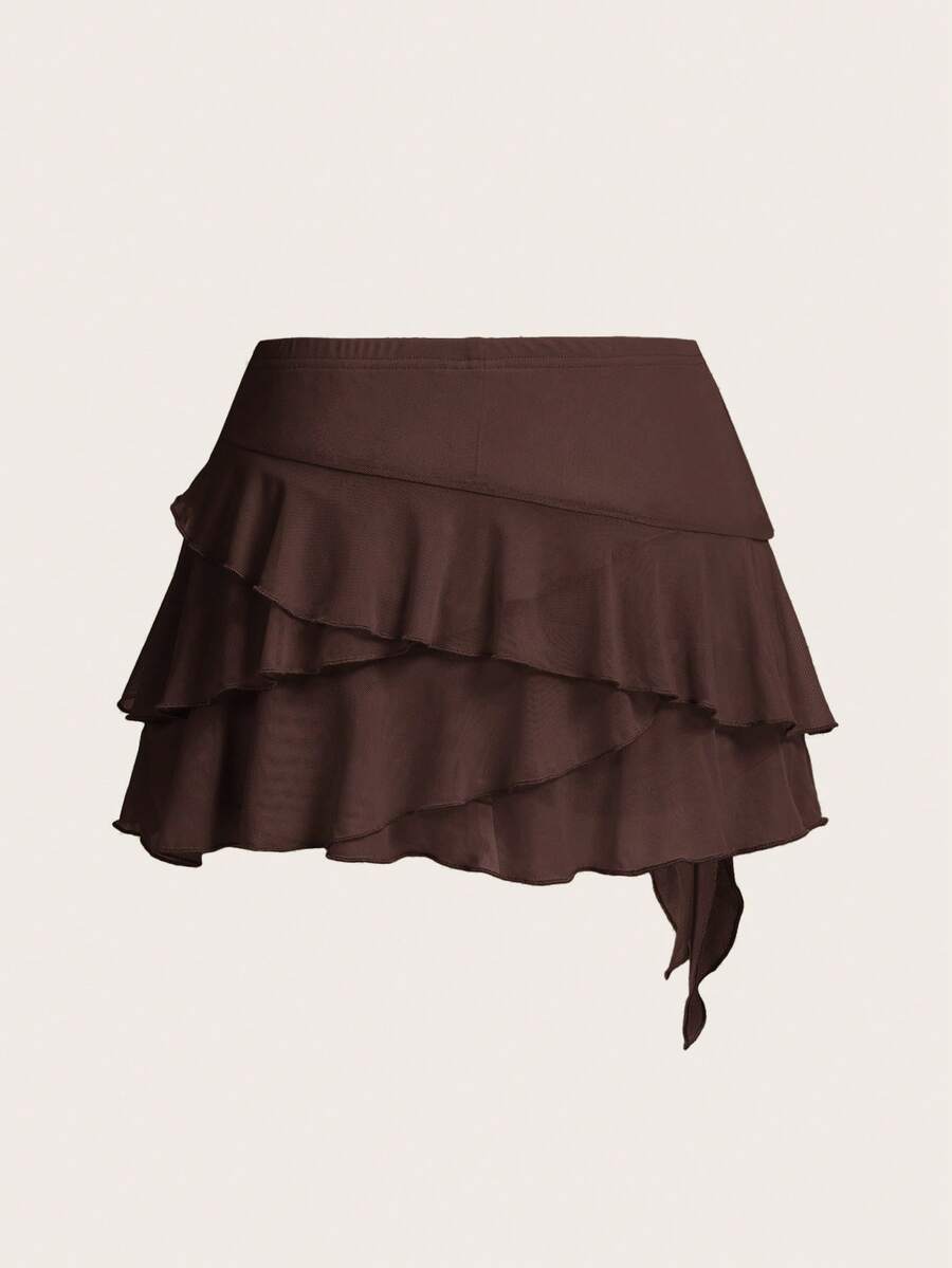 White tiered ruffle trim mini skirt for women with low waist, knot detail, mesh fabric, and casual Y2K boho design.