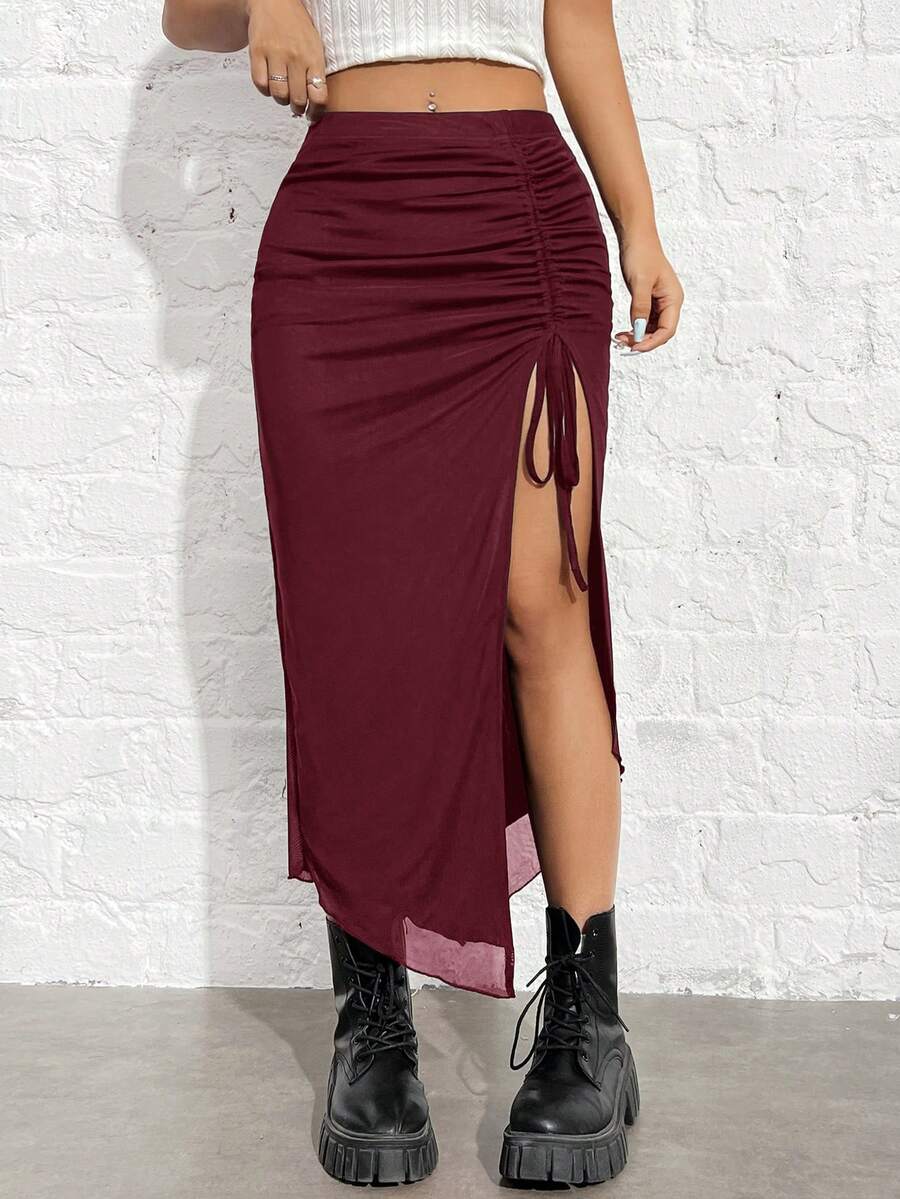 Women's black high-waisted bodycon long skirt featuring a drawstring split thigh detail and mesh fabric.