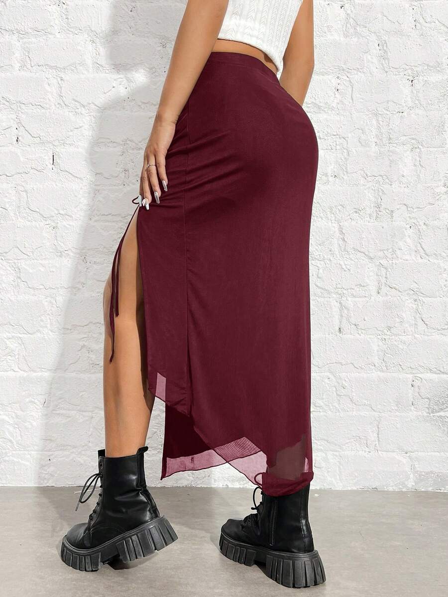 Women's black high-waisted bodycon long skirt featuring a drawstring split thigh detail and mesh fabric.