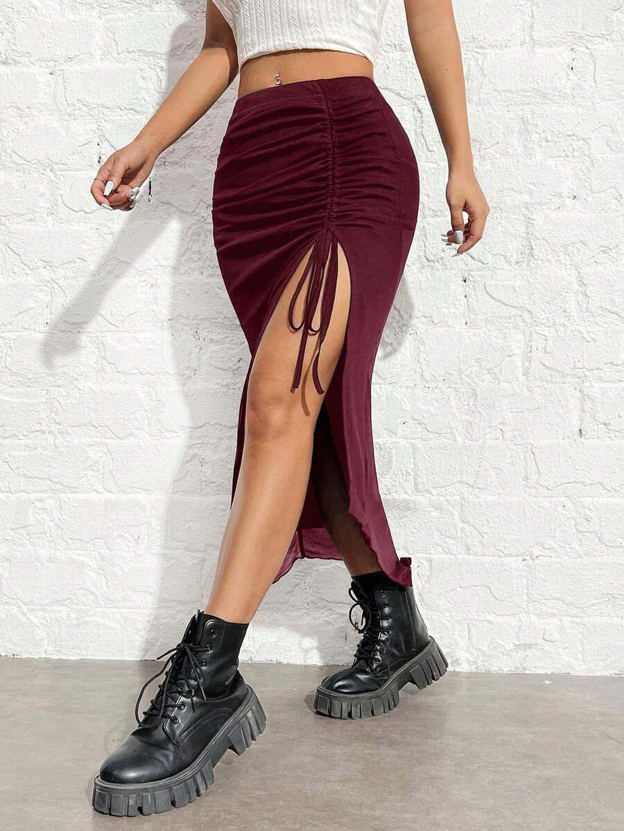 Women's black high-waisted bodycon long skirt featuring a drawstring split thigh detail and mesh fabric.