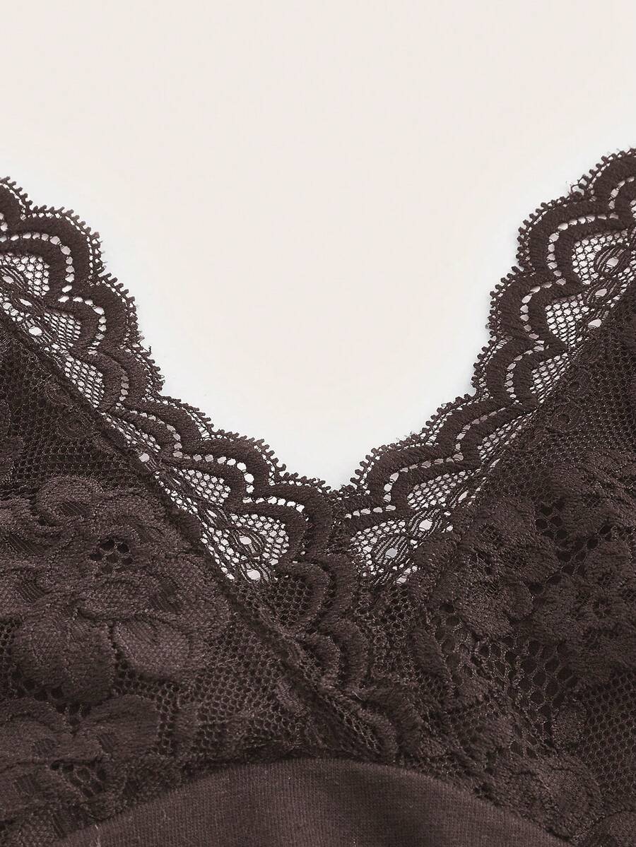 A women's black backless halter top featuring contrast lace trim, ruched front detail, and slim fit soft knitted fabric.