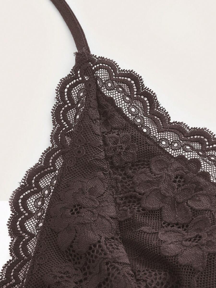 A women's black backless halter top featuring contrast lace trim, ruched front detail, and slim fit soft knitted fabric.