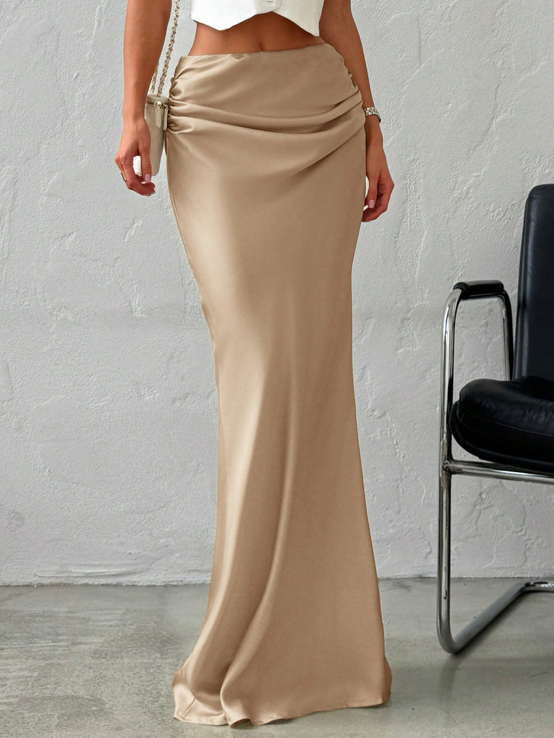 Women's khaki solid color satin maxi skirt featuring an asymmetrical ruched design, zipper closure, and ultra low waistline.