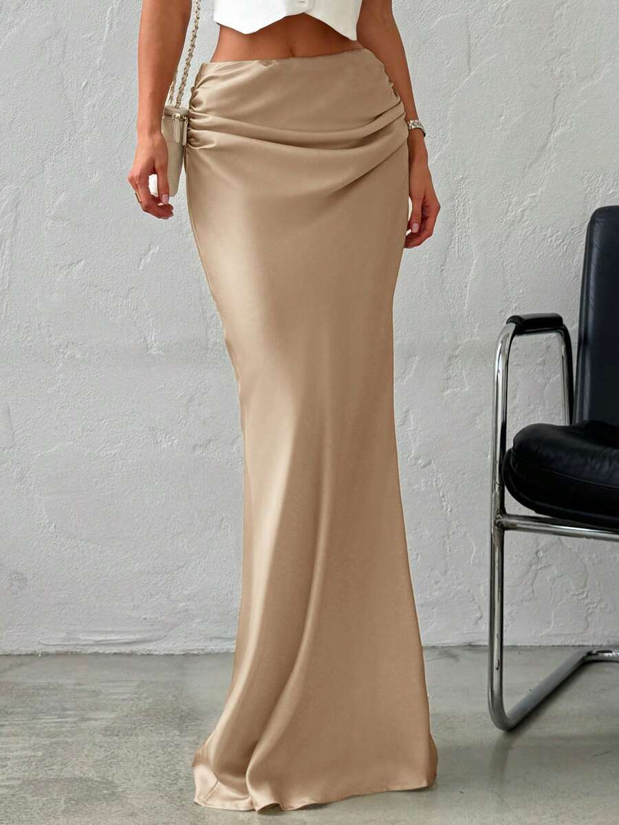 Women's khaki solid color satin maxi skirt featuring an asymmetrical ruched design, zipper closure, and ultra low waistline.