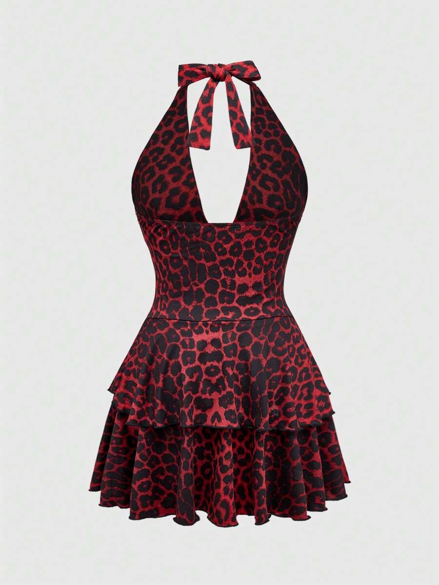 Women's burgundy halter leopard print mini dress featuring a backless cut-out design and tiered layered hem.