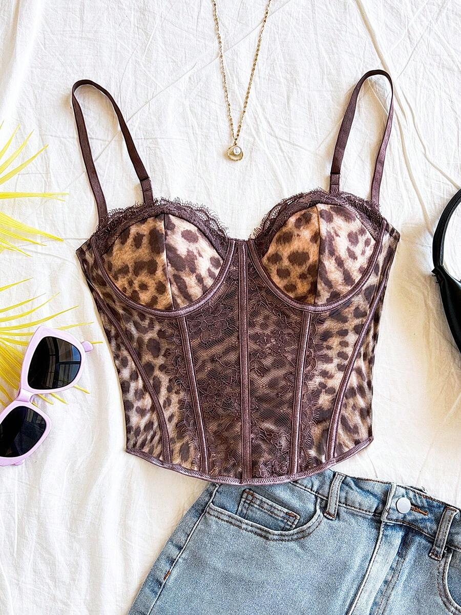 Women's lace bustier camisole top with spaghetti straps, contrast lace, lace-up detail, and an asymmetrical hem in a slim fit design.