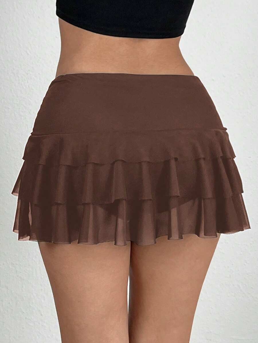 Black tiered ruffle mini cake skirt for women featuring a mid-waist pleated design and layered ruffle hem.