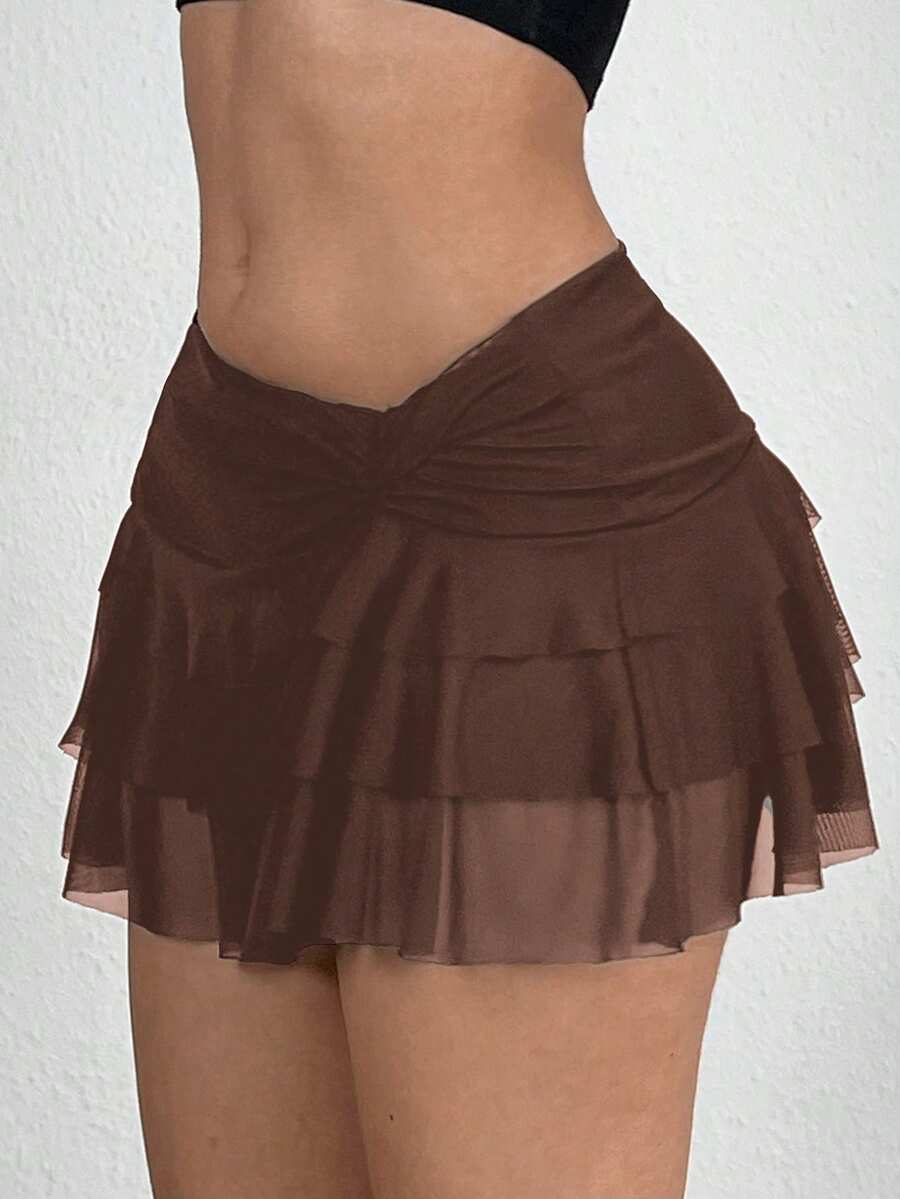 Black tiered ruffle mini cake skirt for women featuring a mid-waist pleated design and layered ruffle hem.