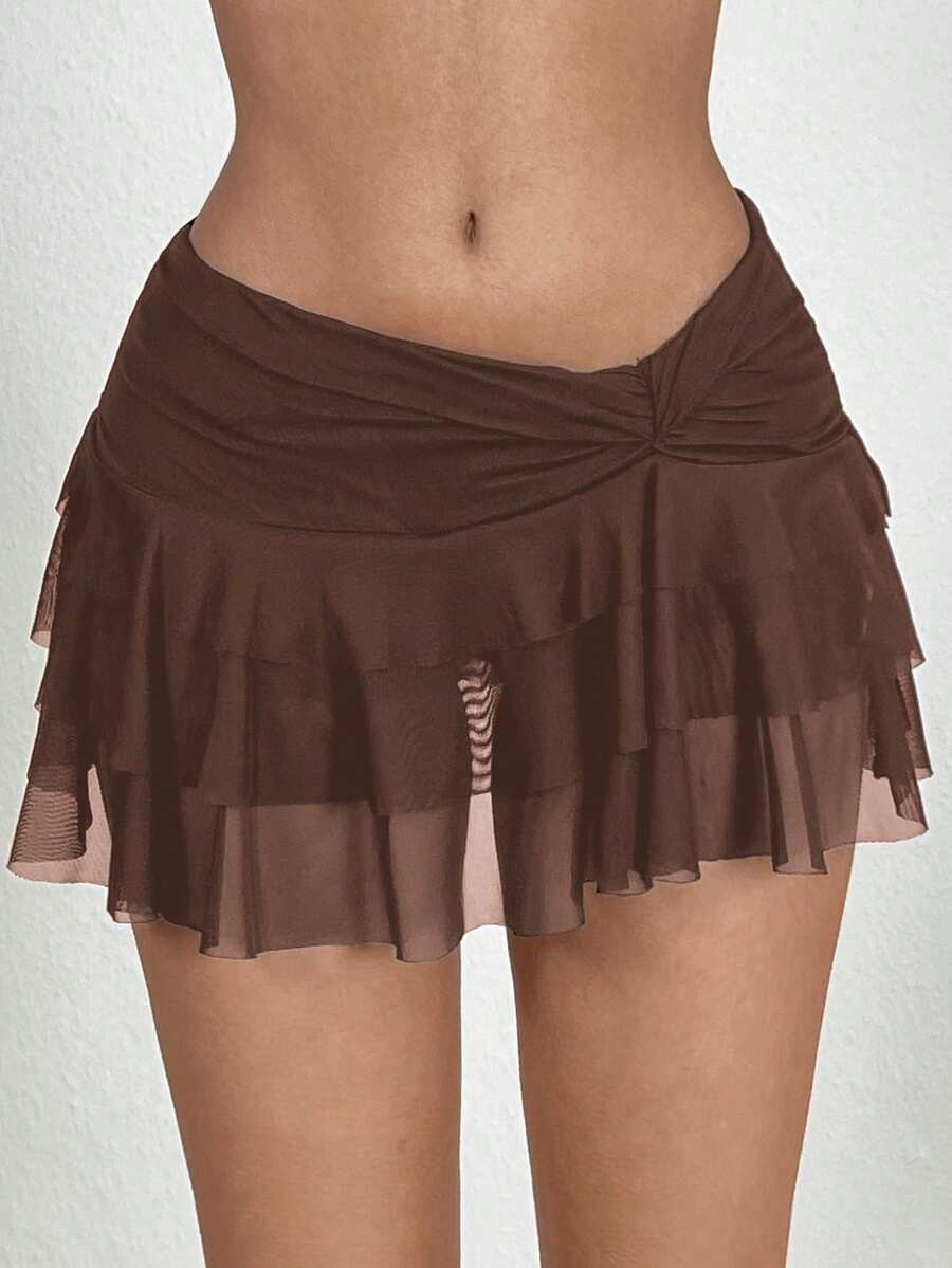 Black tiered ruffle mini cake skirt for women featuring a mid-waist pleated design and layered ruffle hem.