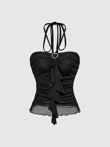 Women's black halter crop top featuring a backless cut, front ring detail, knot accent, asymmetrical hem, and high-stretch mesh fabric.