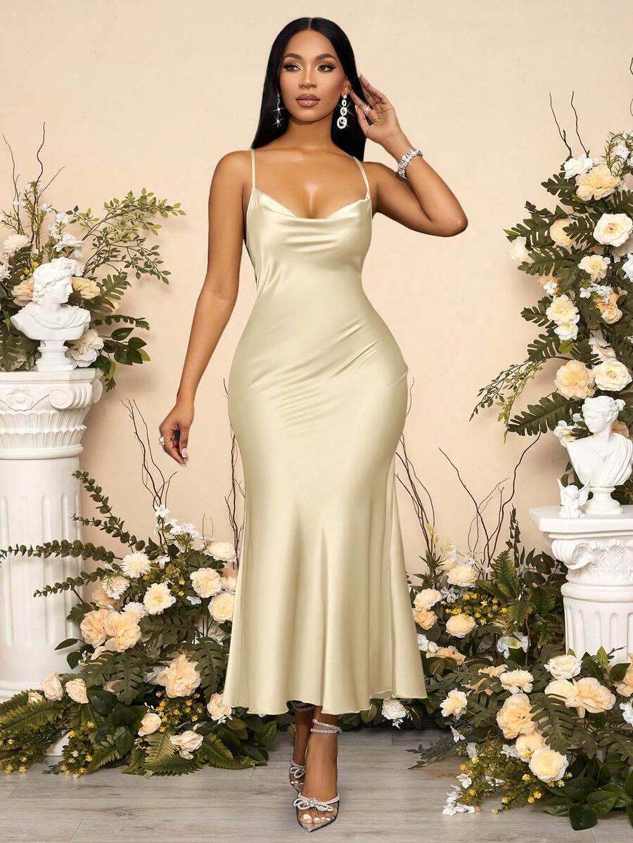 Apricot satin maxi dress featuring a backless criss-cross strap design, spaghetti straps, and elegant mermaid hem silhouette.