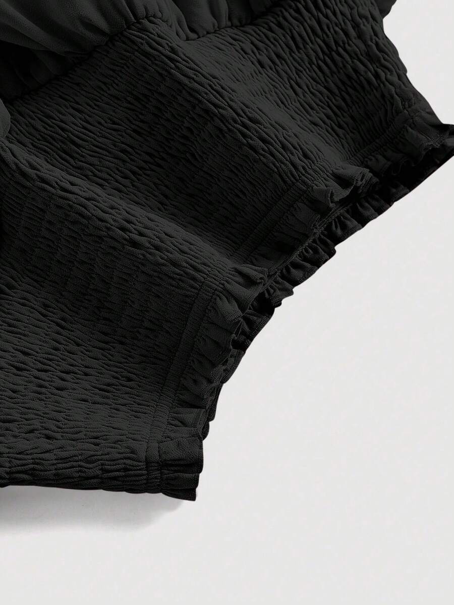 Women's high waist tiered ruffle layered mini skort in black featuring shirred details and ruffle hem.