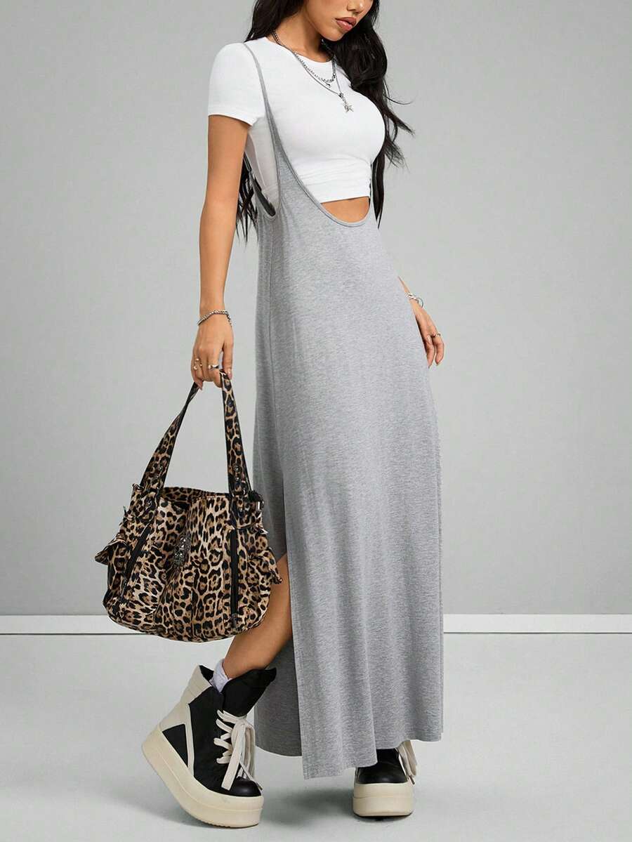 Women's black sleeveless spaghetti strap long cami dress with a side split thigh in high-stretch knitted fabric.