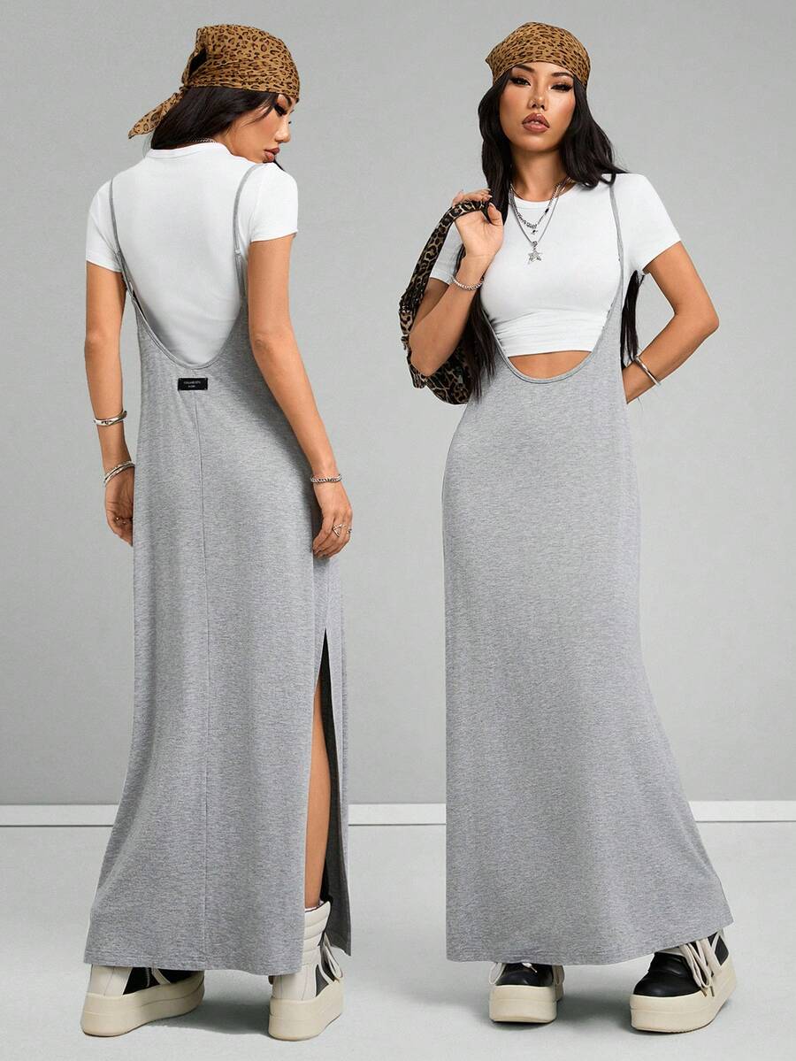 Women's black sleeveless spaghetti strap long cami dress with a side split thigh in high-stretch knitted fabric.