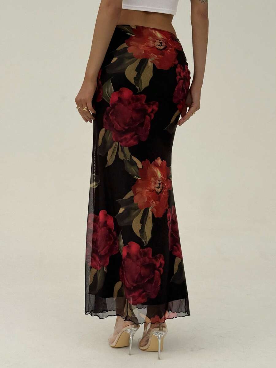 Black floral print mesh maxi skirt for women featuring high waist, ruched asymmetrical design, lettuce trim, and mermaid hem.