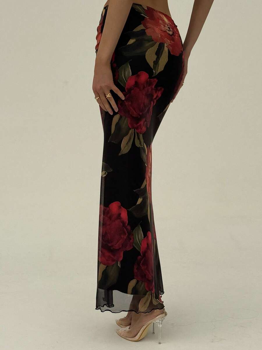 Black floral print mesh maxi skirt for women featuring high waist, ruched asymmetrical design, lettuce trim, and mermaid hem.