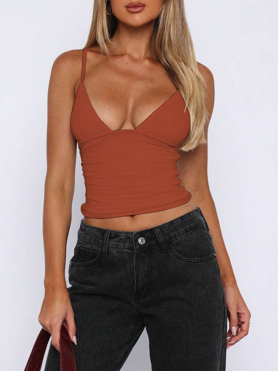 Women's V-neck backless camisole crop top with ruched detailing in a slim fit knit fabric.
