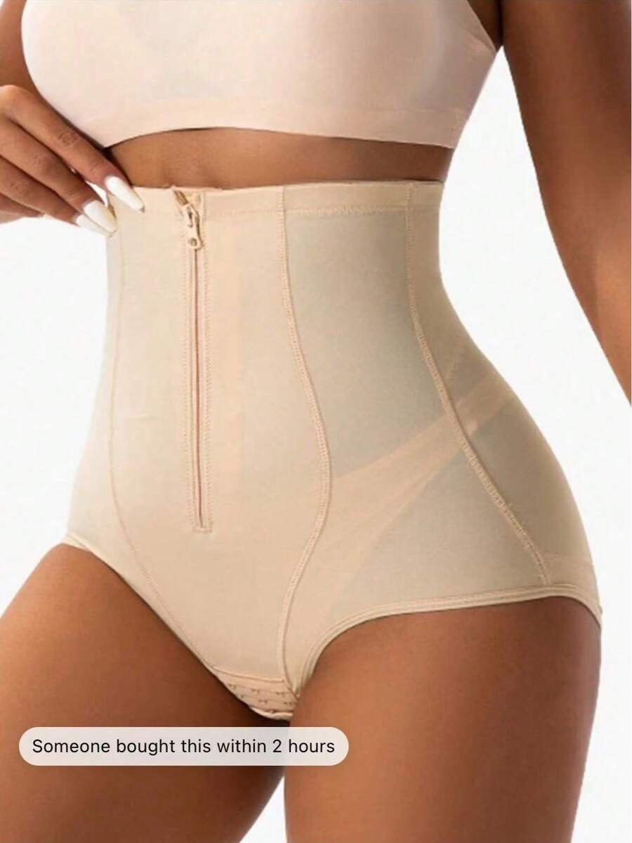 Women's black super high waist shaping pants with zipper closure, strong tummy control, and butt lifting feature.