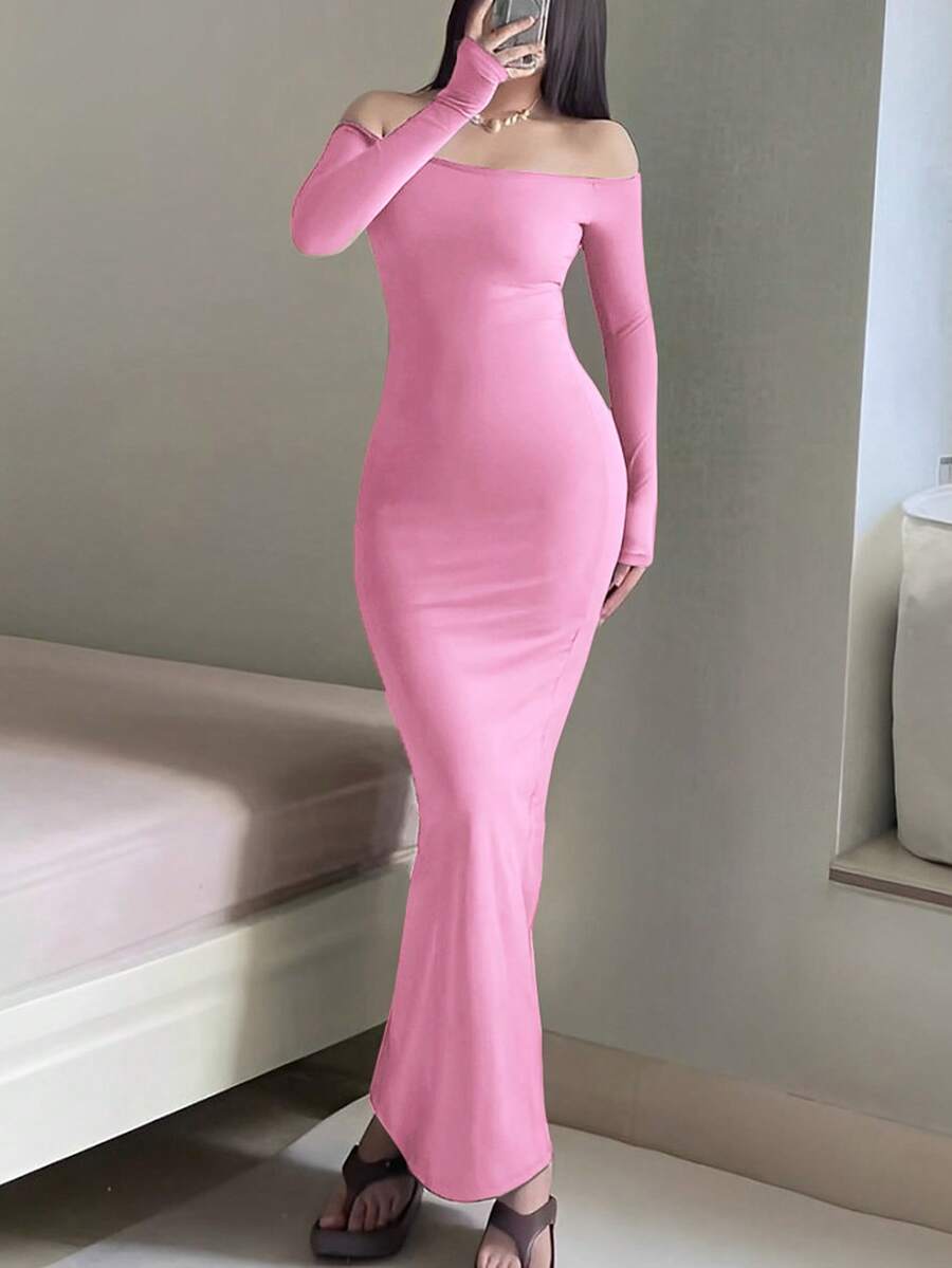 Woman wearing an elegant off-the-shoulder bodycon long dress with backless design and pencil silhouette in high-stretch knitted fabric.