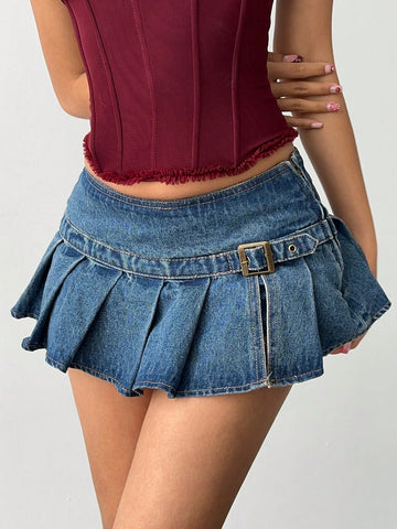 Women's blue denim pleated mini skirt skort featuring a low waist fit with zipper and grommet eyelet details.
