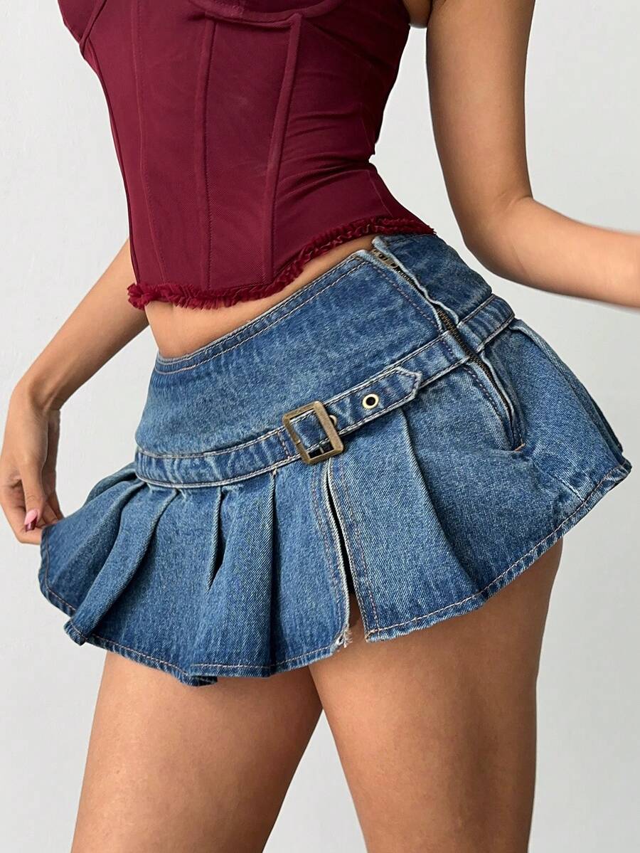 Women's blue denim pleated mini skirt skort featuring a low waist fit with zipper and grommet eyelet details.