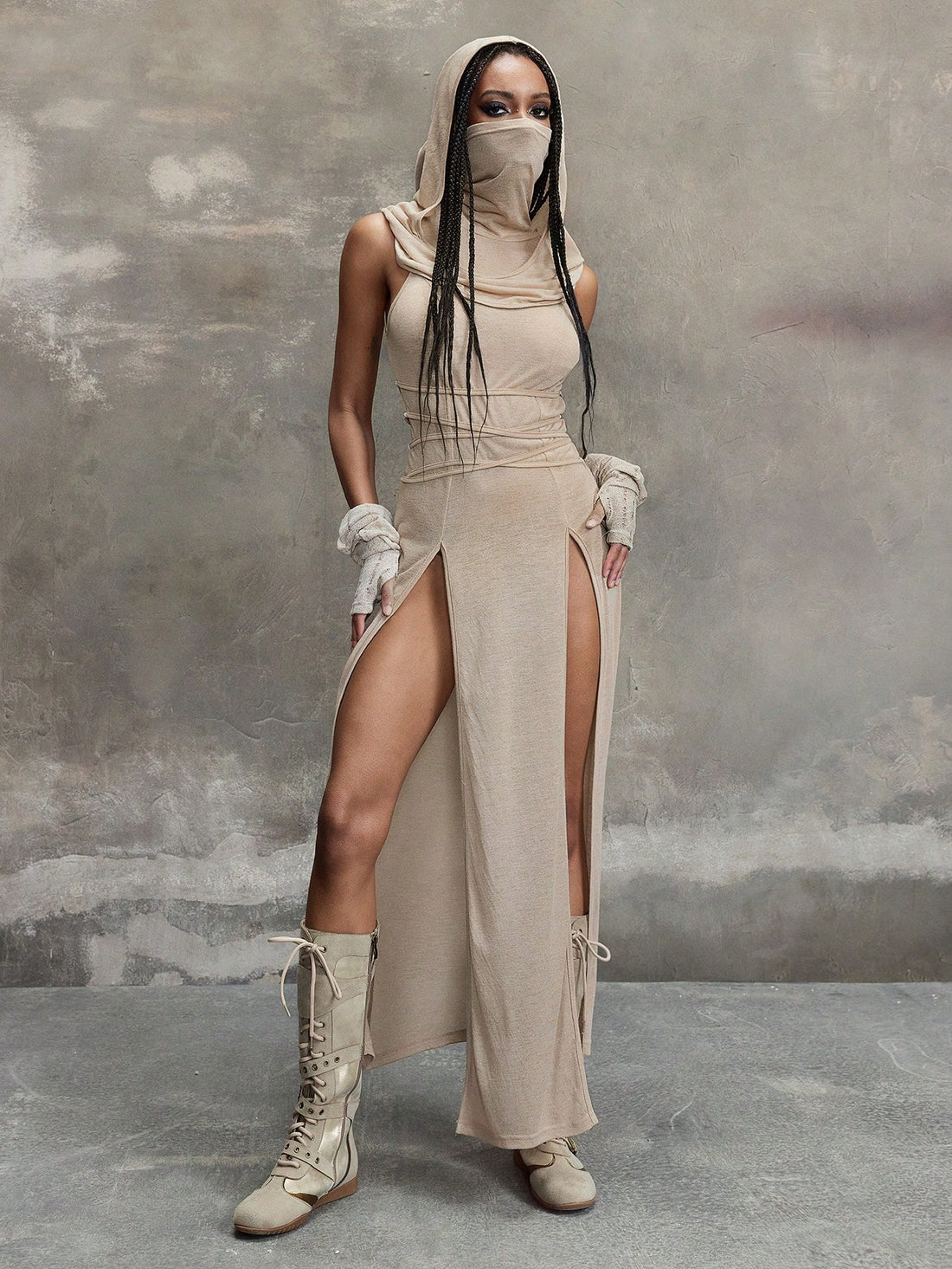 Women wearing a Y2K vintage apocalyptic style hooded long dress featuring short sleeves, backless detail, high thigh slit, and slim fit knitted fabric.