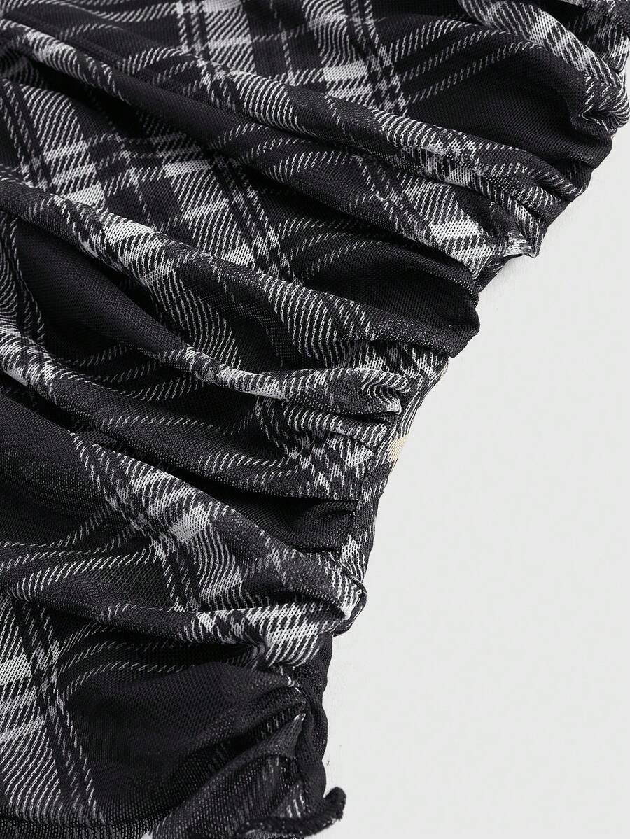 Women's black polka dot strapless tube top made of ruched mesh fabric featuring an asymmetrical hem and matching scarf.