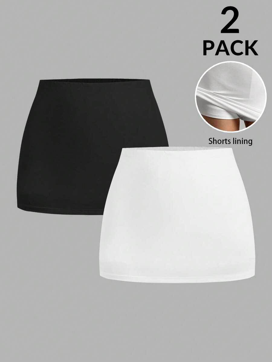 Women's black casual low rise bodycon mini skort with built-in shorts in knitted plain stretch fabric.