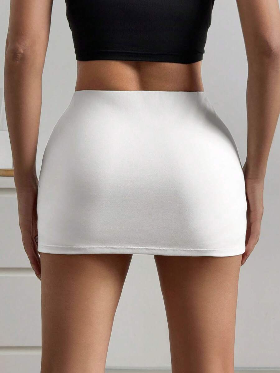 Women's black casual low rise bodycon mini skort with built-in shorts in knitted plain stretch fabric.