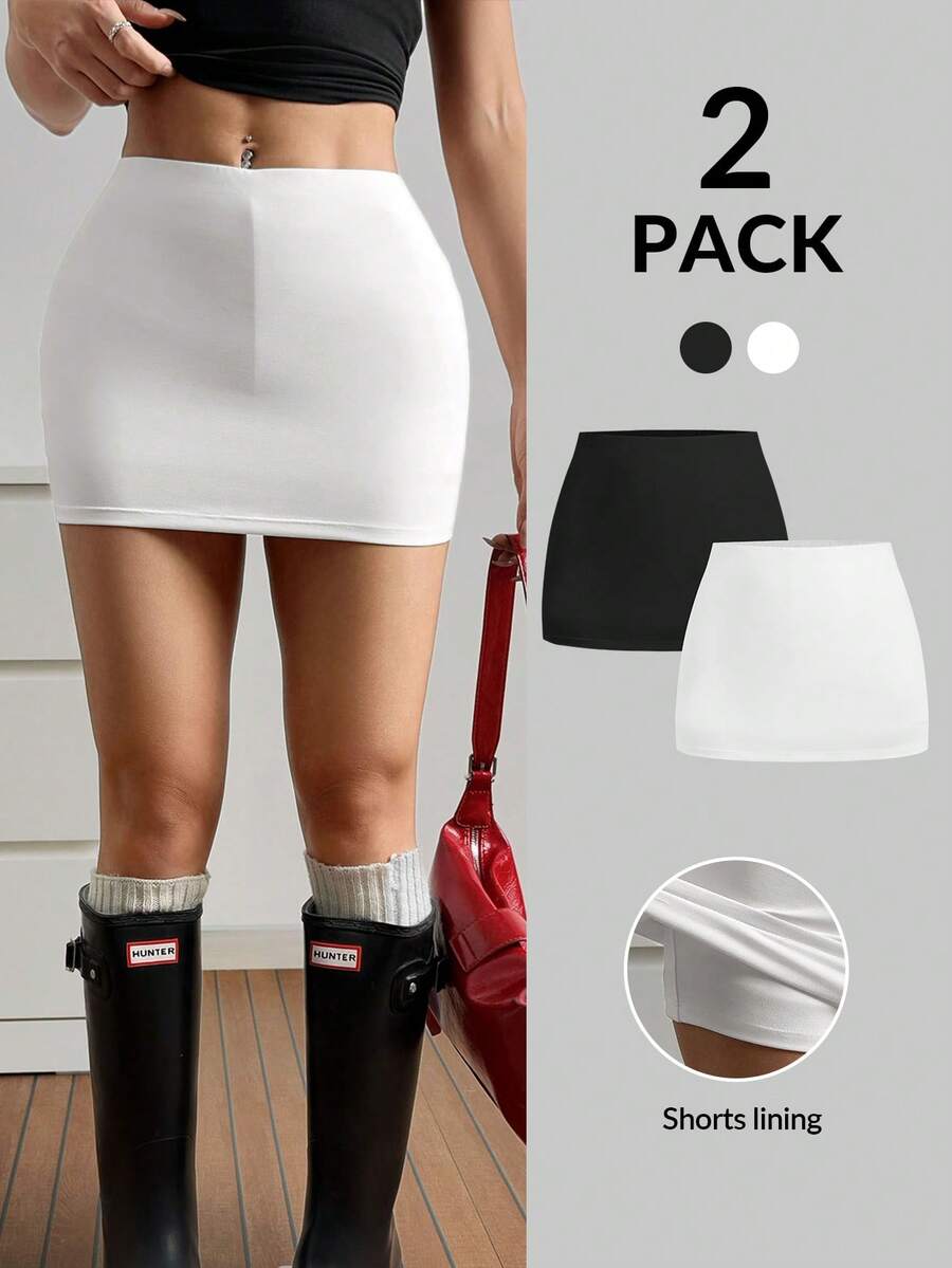 Women's black casual low rise bodycon mini skort with built-in shorts in knitted plain stretch fabric.