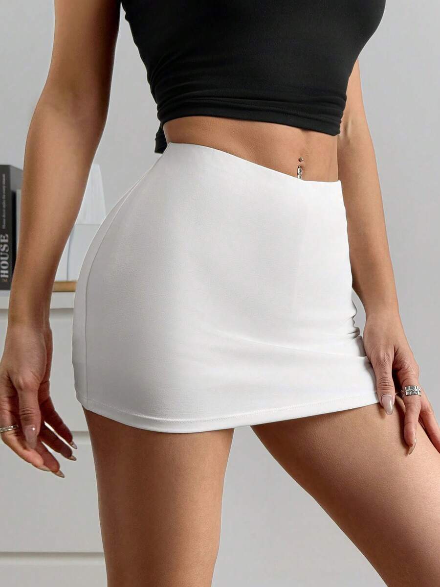 Women's black casual low rise bodycon mini skort with built-in shorts in knitted plain stretch fabric.