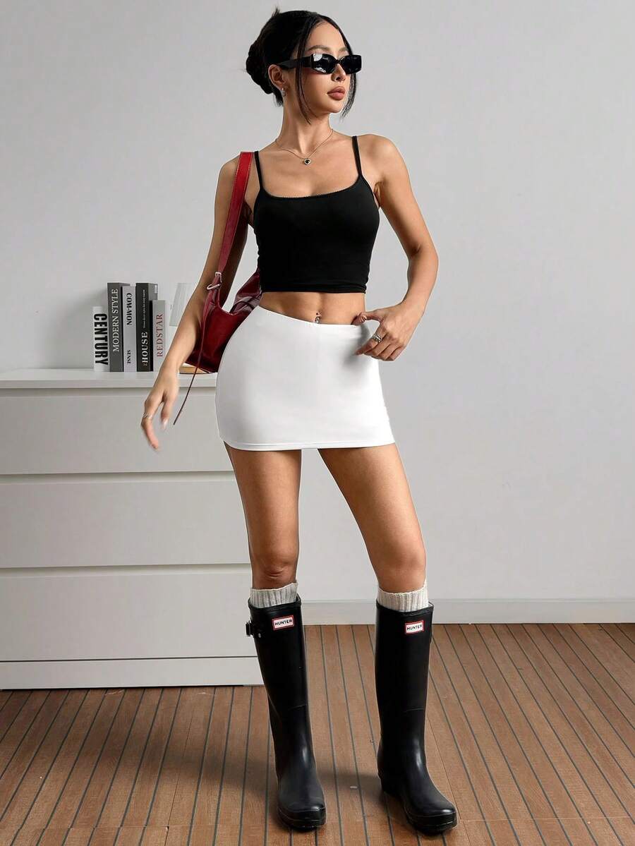 Women's black casual low rise bodycon mini skort with built-in shorts in knitted plain stretch fabric.
